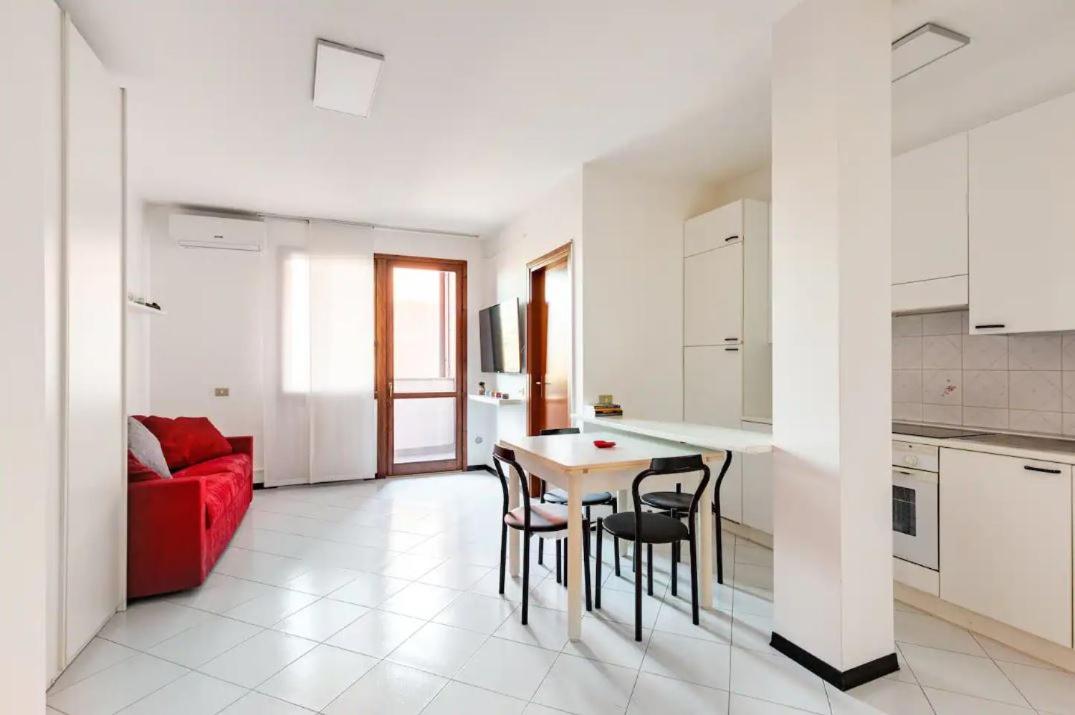 Living area with dining table, kitchen and sofa